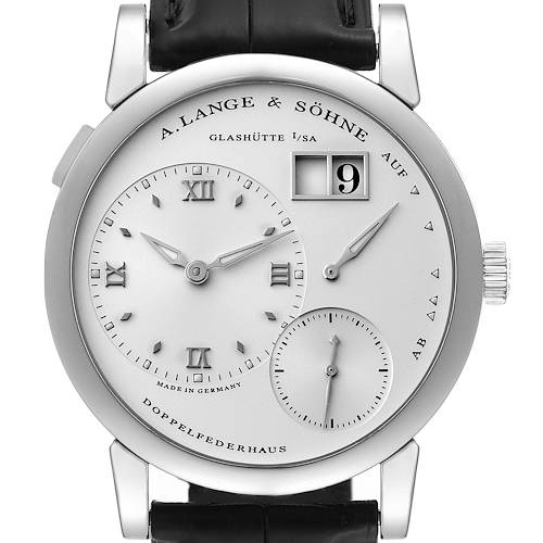 The image shows a front view of an A. Lange & Sohne Lange 1 101.039 Men's White Gold Silver Dial watch, highlighting its dial, hands, date display, and leather strap.