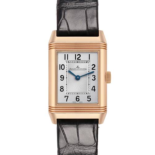 The Jaeger-LeCoultre Reverso watch is shown from a front angle, displaying the dial and leather strap.