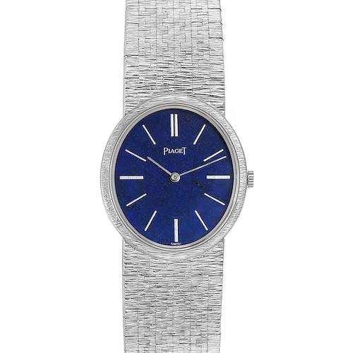 The Piaget 9822A6 men's watch is shown from a top-down angle, displaying the blue dial, hour markers, and textured metal bracelet.