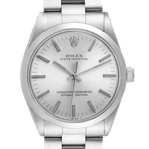 The Rolex Oyster Perpetual 1002 Men's Stainless Steel Silver Dial watch is shown from a front angle, highlighting the face, bezel, hands, and part of the bracelet.